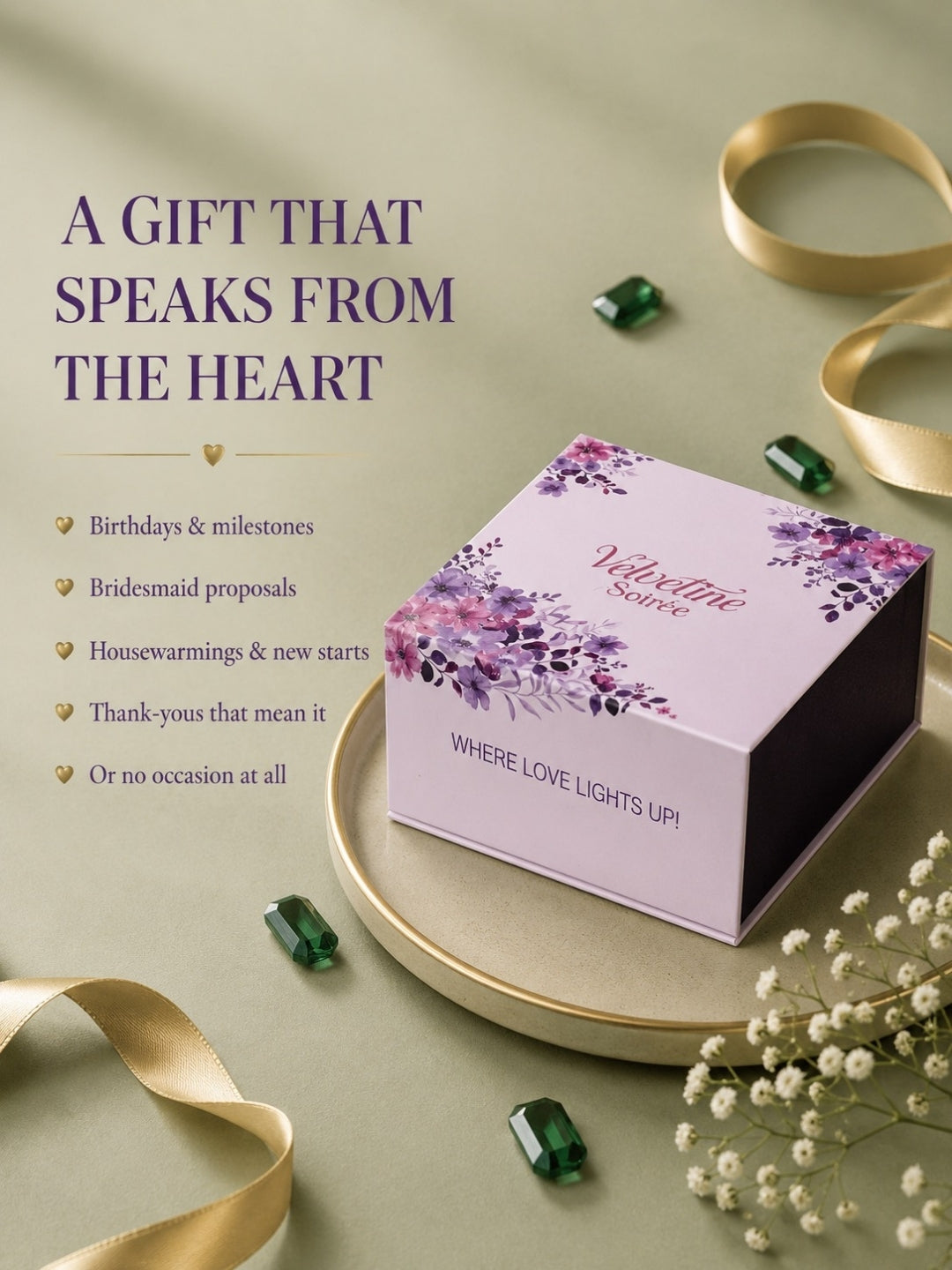 A lavender gift box with purple floral illustrations and the words 'Velvetine Solace' and 'WHERE LOVE LIGHTS UP!' sits on a round gold tray. The scene is styled with gold ribbons, small green gemstones, white baby's breath flowers, and text on the left reading 'A GIFT THAT SPEAKS FROM THE HEART' with example occasions listed below.