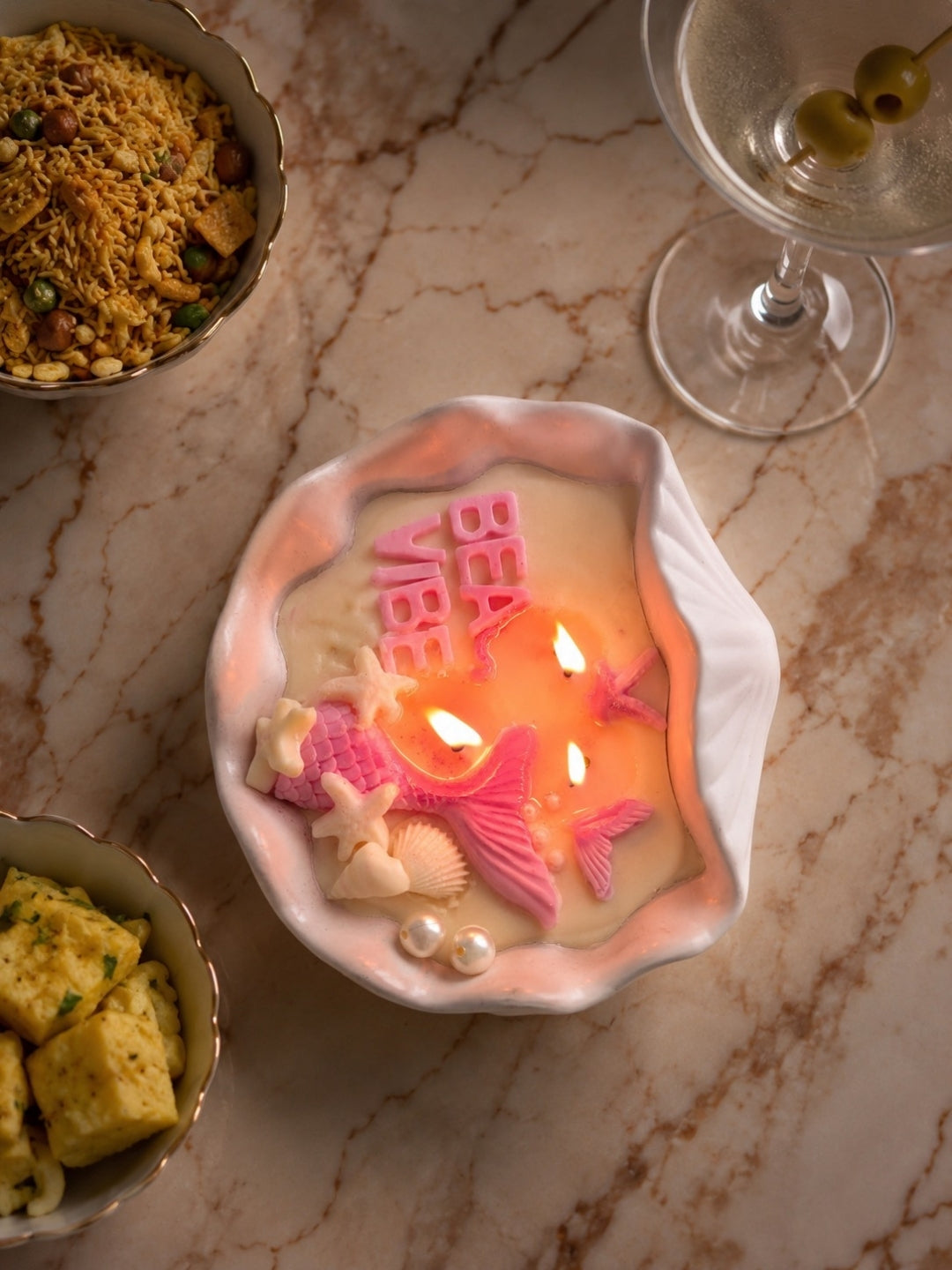 Wax melting in conch shell candle jar. The candle Beach Vibes has 3 wicks and smells refreshing and marine like
