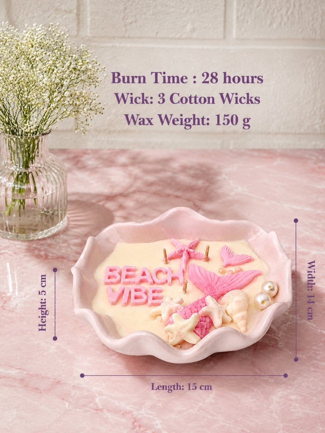A pink scalloped ceramic candle holder filled with a cream-colored wax candle decorated with pink and white seashell and starfish motifs, with the words 'BEACH VIBE' in pink. The image includes dimension lines showing the candle holder's height, length, and width, along with text detailing its burn time, wick count, and weight.