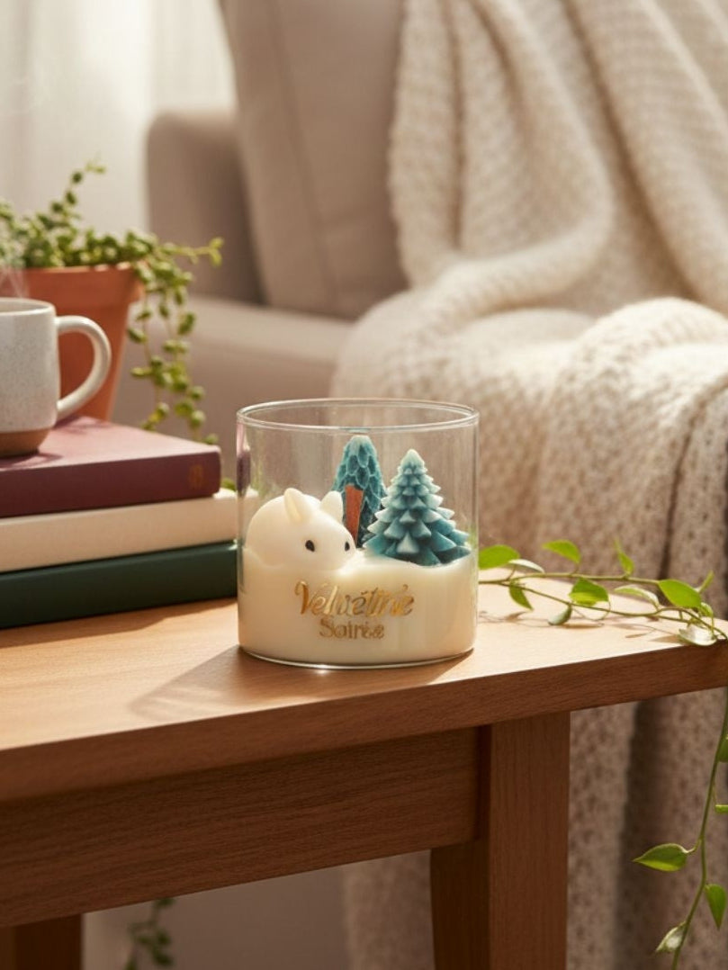 Frost and Fur By Velvetine Soirée is on a table next to couch, it has a cute rabbit and S-Shaped Wooden Wick that will sizzle for real