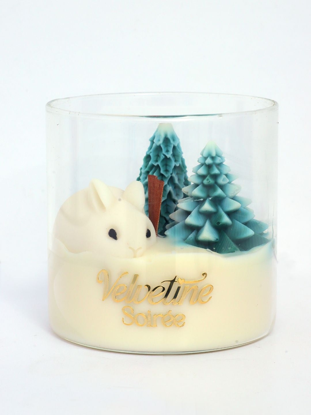 Frost n fur Candle jar in white background. It has rabbit and pin trees and depicts winter. It smells like pine and cedar wood like you are walking in pine forest