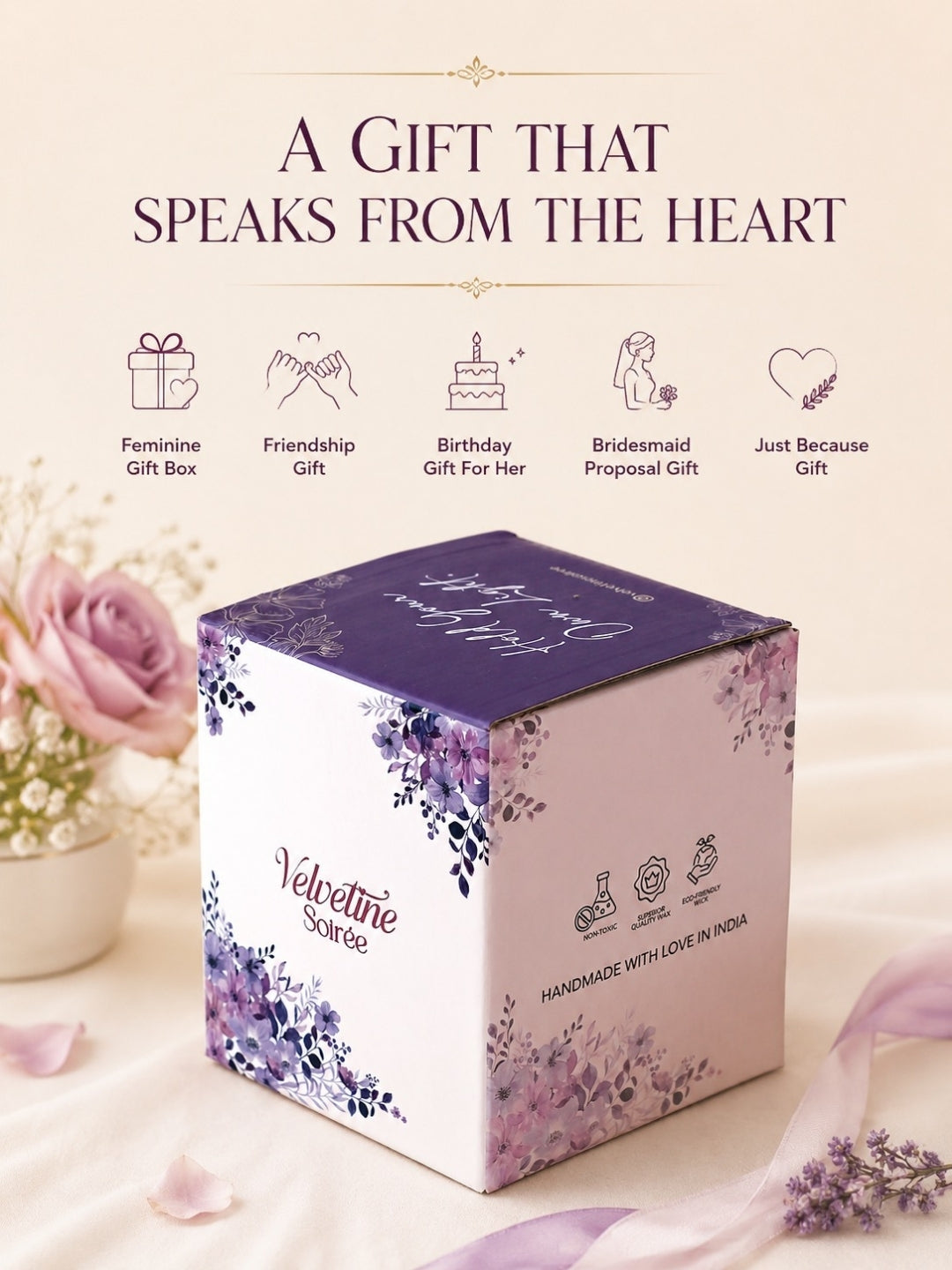 A square gift box with a purple lid and lavender floral illustrations on a white front, styled on a soft cream background with pink roses and text reading 'A GIFT THAT SPEAKS FROM THE HEART.' The box is branded 'Velvetine Soraya.
