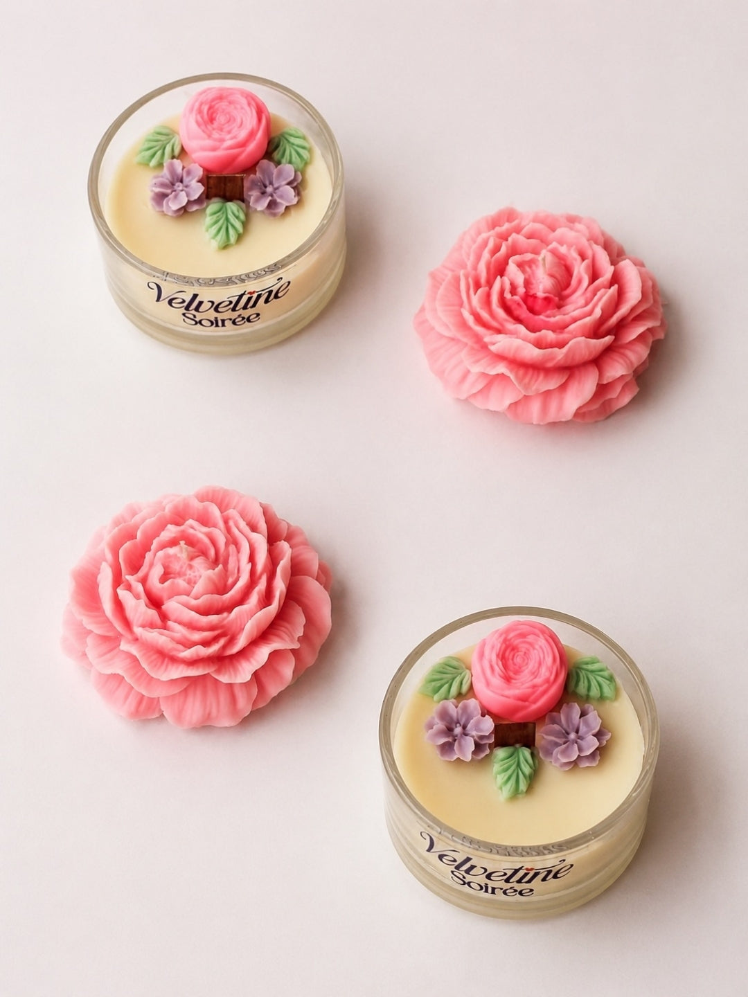Secret Garden Candle Set in White Background. there are 2 candle jars with citrus and woody fragrance and lavender smelling peony decorative candles.